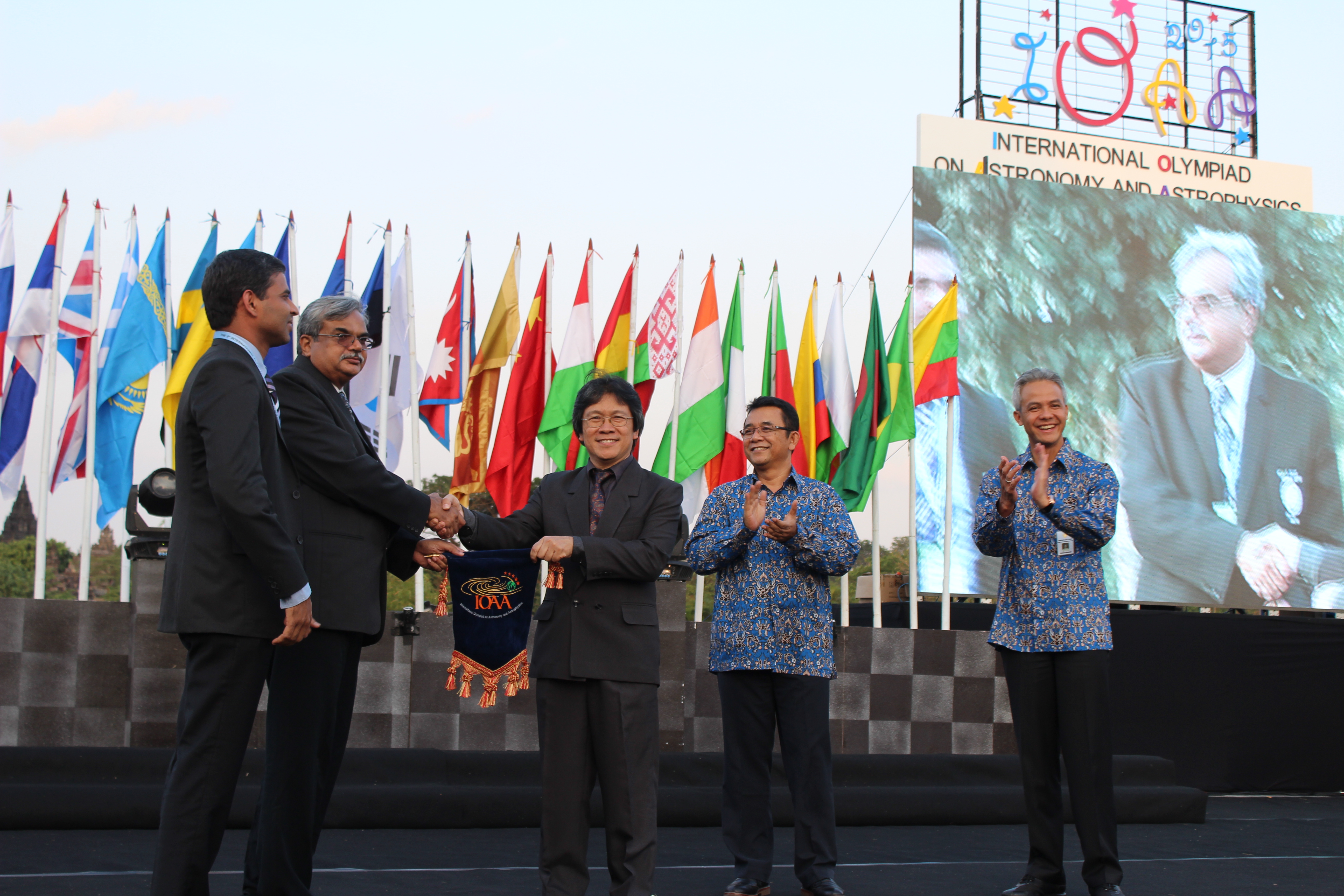 Prof. M. N. Vahia (2016 host) accepts IOAA flag from Prof. Chatief Kunjaya (President of IOAA and 2015 host).